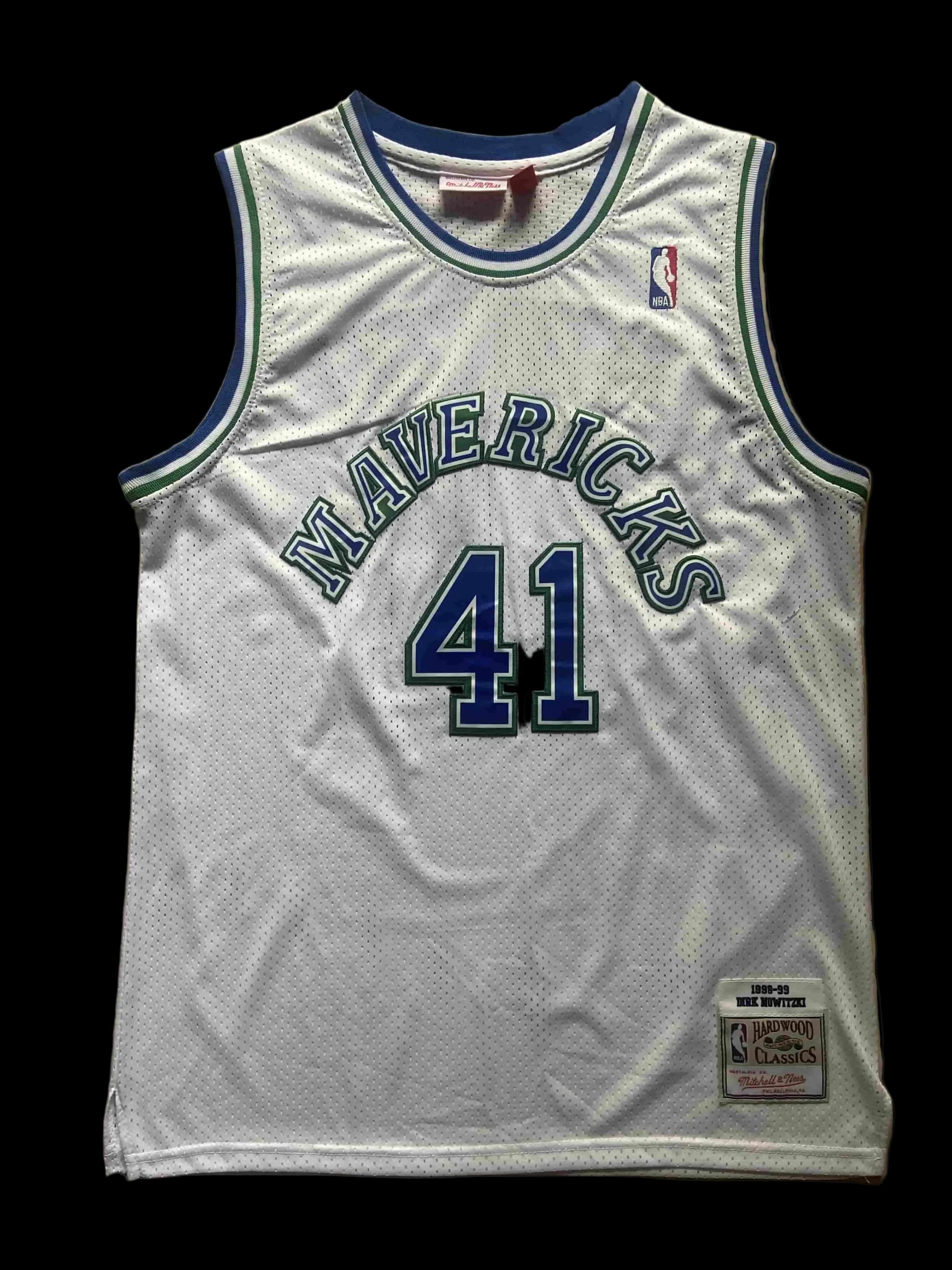 White basketball jersey with 'Mavericks' and number '41' on a beige background